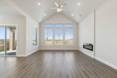 Unfurnished living room with a glass covered fireplace, dark wood finished floors, a ceiling fan, high vaulted ceiling, and recessed lighting