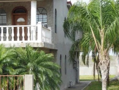 View of side of home with stucco siding and a balcony
