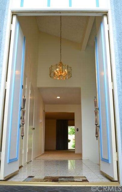 Formal entry way with high vaulted ceiling.