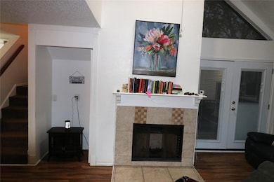 Living room featuring a textured ceiling, hardwood