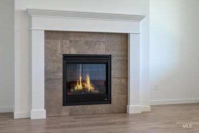 Detailed view of a fireplace and wood finished floors