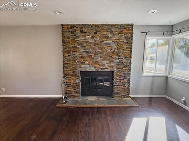 Details featuring a stone fireplace and hardwood /