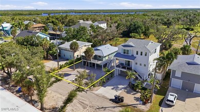 Aerial view of residential area featuring a large body of water and property boundaries - Virtually Edited Image