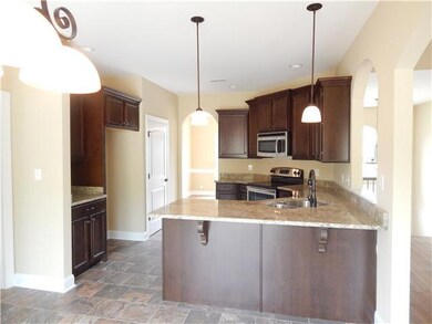 Wonderfully open kitchen.  Granite countertops, stainless steel appliances, workstation, beautiful lighting.