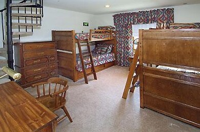 Bunk room with spiral staircase leading