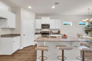 Kitchen featuring visible vents, wood finished flo