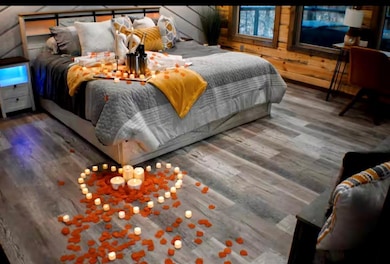 Bedroom featuring wood walls and wood finished flo
