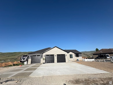 View of front of house featuring a garage, driveway, and a mountain view