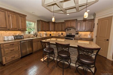 Gorgeous kitchen features custom cabinets, granite