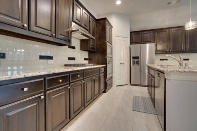 Kitchen with tasteful backsplash, stainless steel 