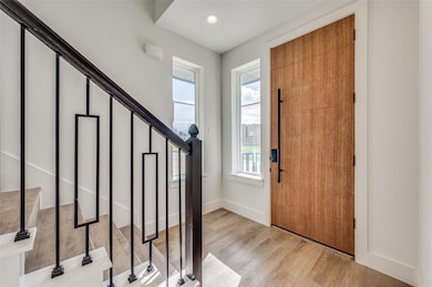 Foyer entrance with light wood-type flooring