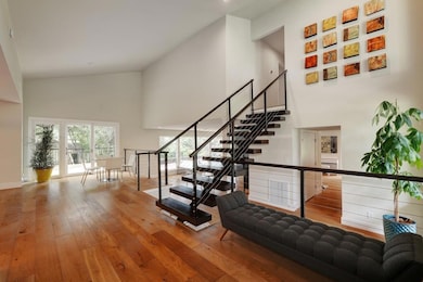 Stairs with a high ceiling, hardwood / wood-style