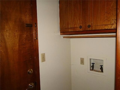 Laundry area with washer hookup and cabinet space