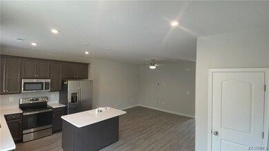 Kitchen featuring a center island, ceiling fan, st