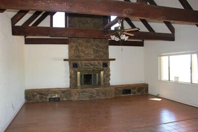 Great room w/ rock fireplace wood beams
