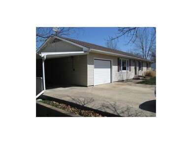 Attached garage plus a carport with storage