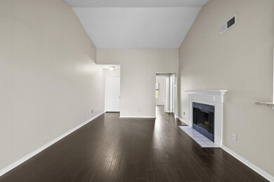 Unfurnished living room with a tile fireplace, ba