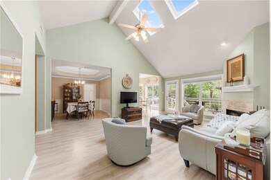 Living room featuring high vaulted ceiling, a chan