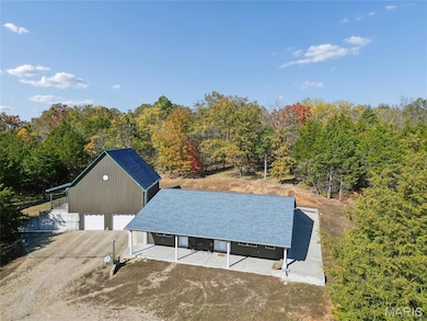 View from above of property with a heavily wooded area