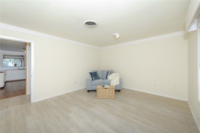 Unfurnished room featuring crown molding and light