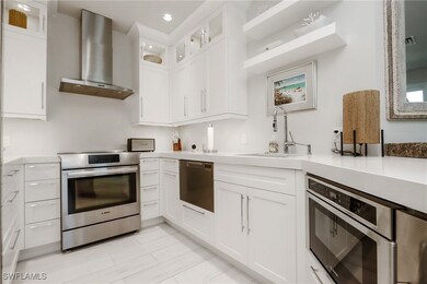 Kitchen featuring wall chimney exhaust hood, stain