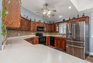 Kitchen with black appliances, a sink, tasteful backsplash, ceiling fan, and lofted ceiling