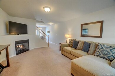 Living room features a corner gas fireplace.