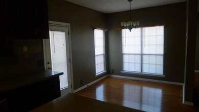 Large Eating Area Off Kitchen Beside Windows
