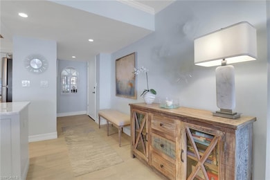 Corridor featuring recessed lighting, baseboards, light wood finished floors, and ornamental molding