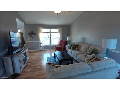 Great Room with vaulted ceiling and natural light