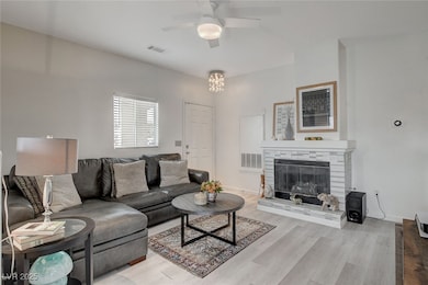 Living room featuring a glass covered fireplace, w