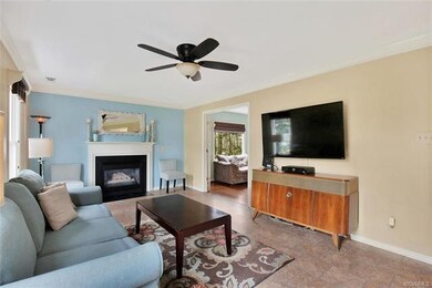 Spacious family room with ceiling fan, crown moldi