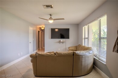 Tiled living room with ceiling fan