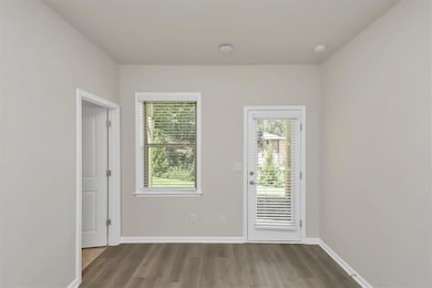 Doorway featuring wood finished floors and baseboards