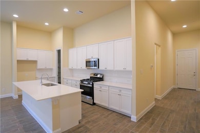 Kitchen with stainless steel appliances, a sink, 