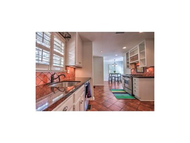 Large kitchen with granite countertops, tile paver