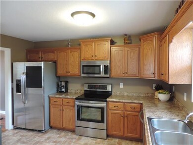 THE KITCHEN OFFERS LOTS OF CABINET SPACE AND STAIN