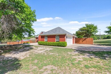View of side of home featuring concrete driveway, 