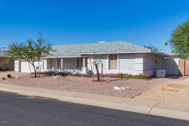 Front of Home with stucco finish and 2 car garage!