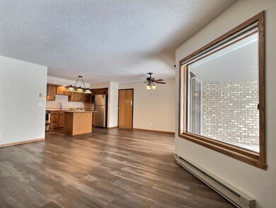 Open floor plan for living / dining / kitchen with a large picture window in the living room
