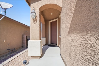 Property entrance featuring stucco siding
