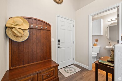 Mudroom with dark wood-style flooring and baseboards