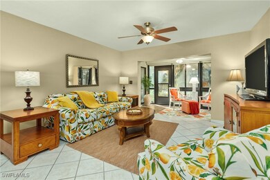Living room featuring ceiling fan and light tile p