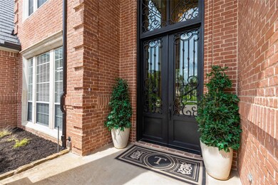 Beautiful custom iron door welcome guest upon arrival from the circular drive.