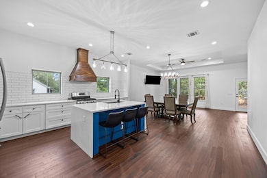 Kitchen featuring stainless steel gas range, prem
