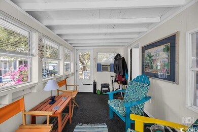 Sunroom / solarium featuring carpet floors, beam c