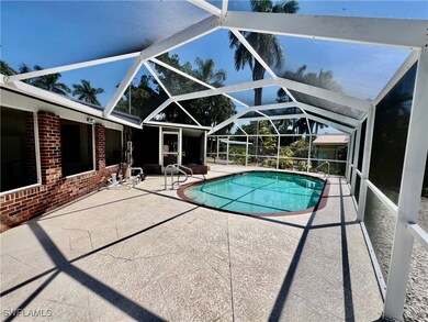 Outdoor pool with a lanai and a patio area