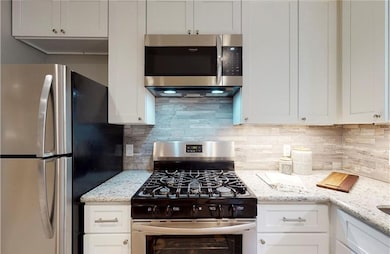 Kitchen with appliances with stainless steel finis
