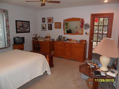 Master suite with door to forested yard