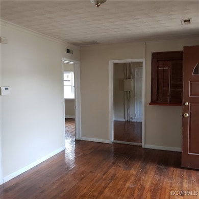 Unfurnished room featuring hardwood / wood-style f